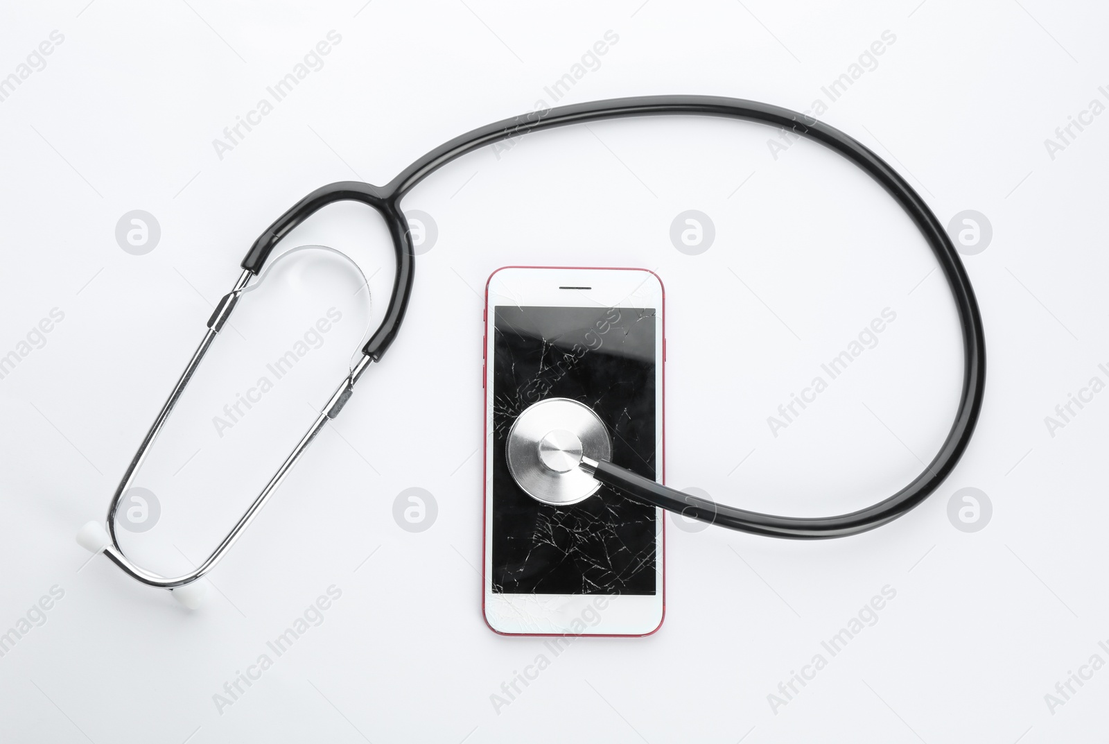 Photo of Modern smartphone with broken display and stethoscope on white background, top view. Device repair service