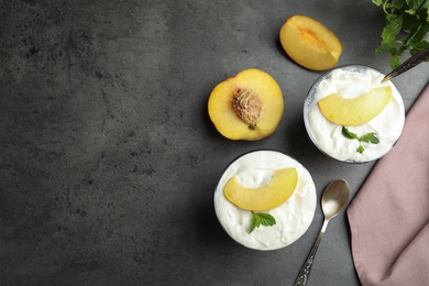 Photo of Tasty peach dessert with yogurt served on grey table, flat lay. Space for text