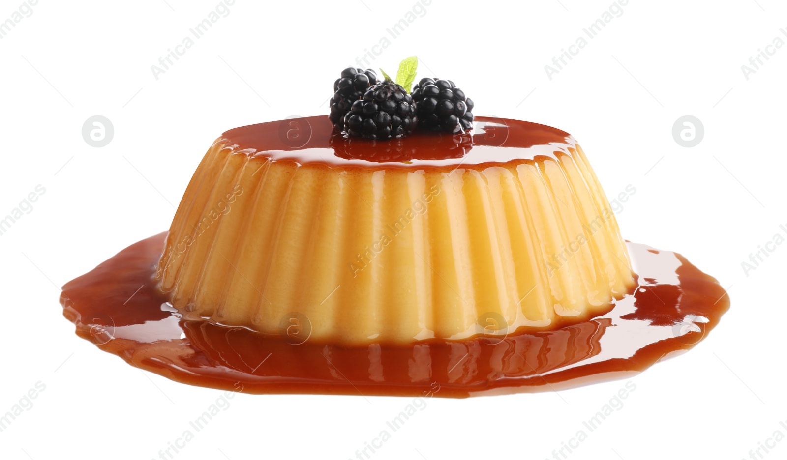 Photo of Delicious pudding with caramel and blackberries isolated on white