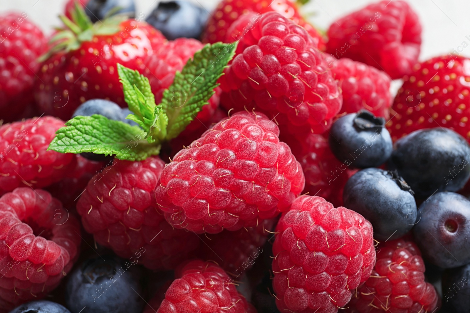 Photo of Raspberries, strawberries, blueberries and mint, closeup