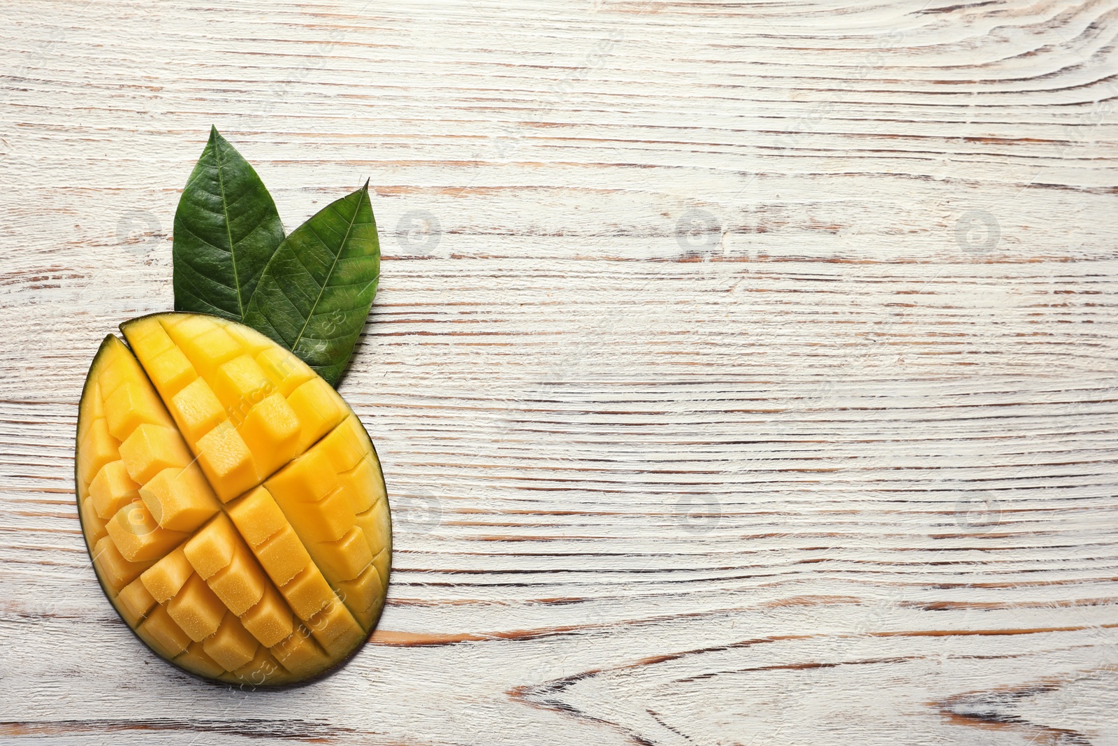 Photo of Flat lay composition with mango on white wooden background. Space for text