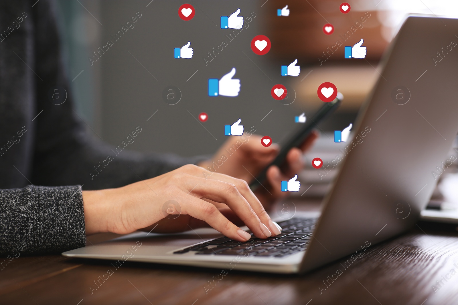 Image of Young woman using laptop and smartphone indoors, closeup. Social media