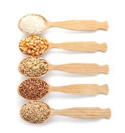 Photo of Spoons with different types of grains and cereals on white background