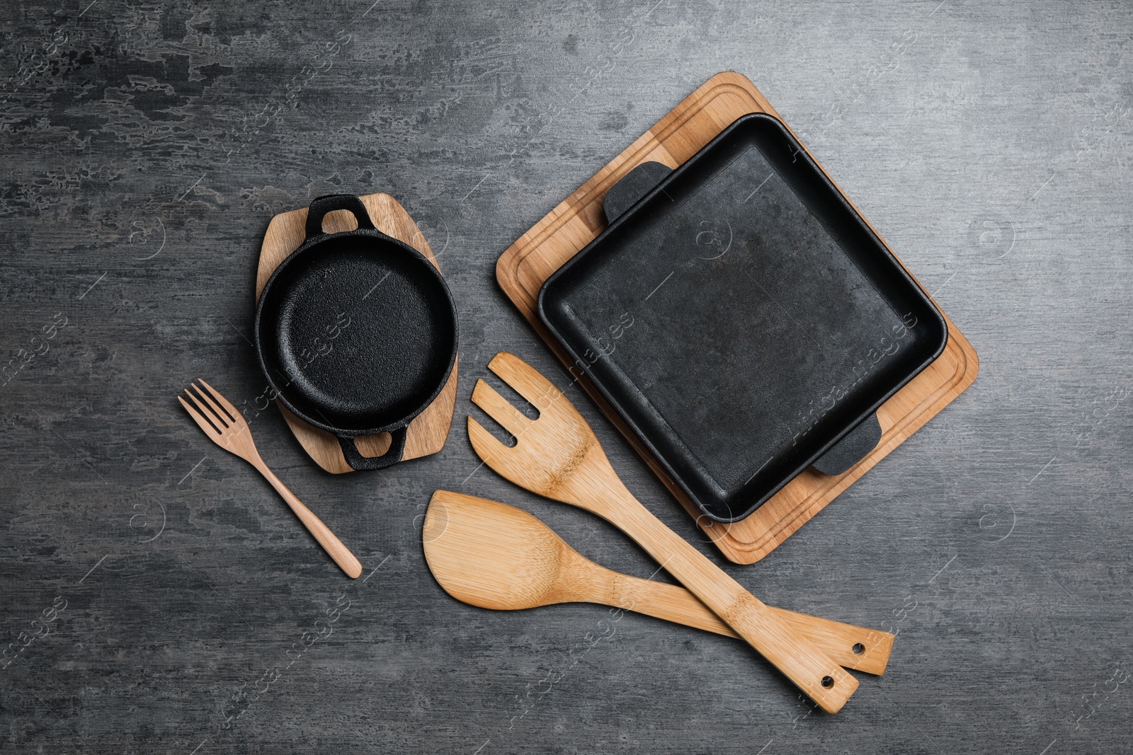 Photo of Set of cooking utensils on grey table, flat lay