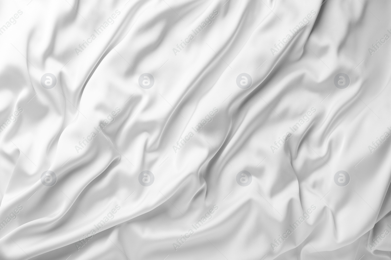 Photo of Texture of white silk ripple fabric as background, top view