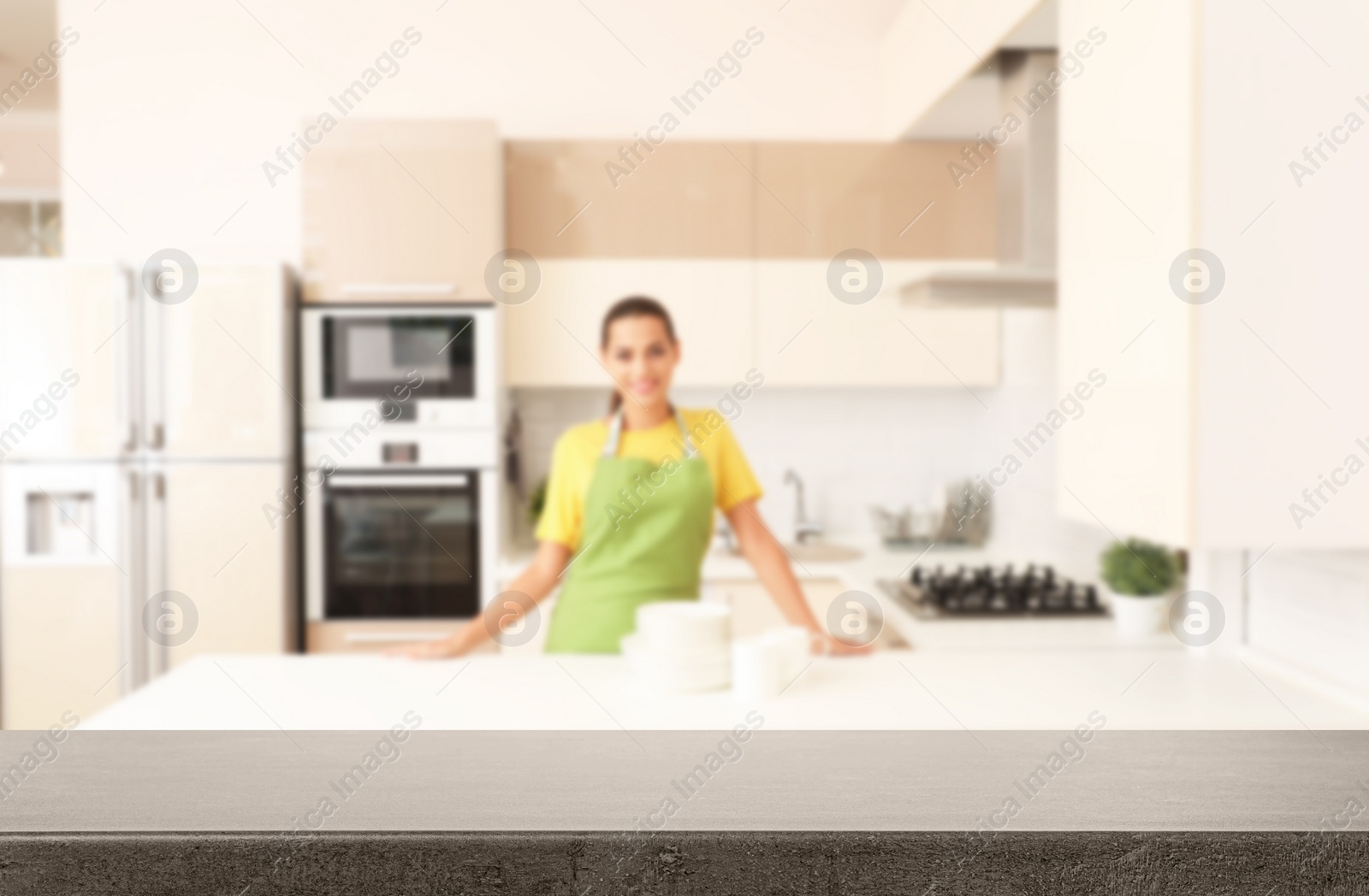 Image of Happy woman with clean dishes in kitchen, focus on empty table