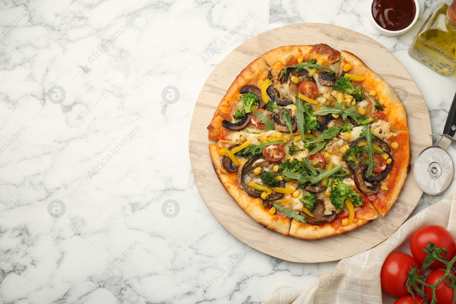 Photo of Delicious vegetarian pizza served on white marble table, top view. Space for text