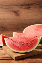 Photo of Slices of tasty ripe watermelon on wooden table