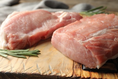 Fresh raw cut meat on wooden board, closeup