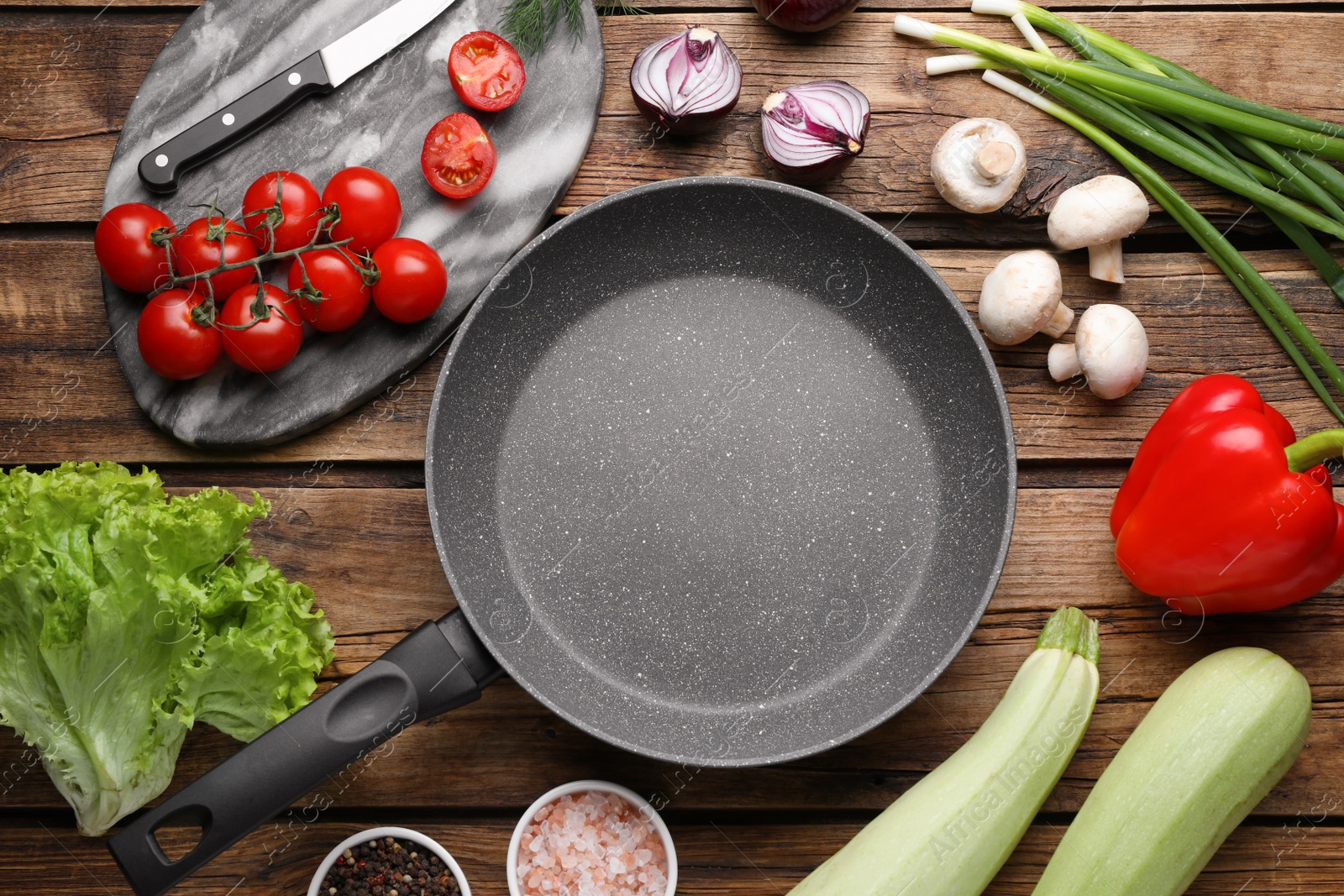 Photo of Flat lay composition with frying pan and fresh products on wooden table