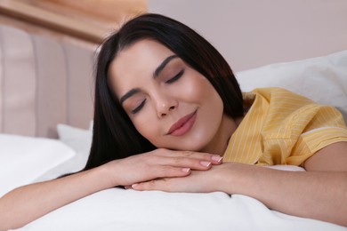 Photo of Woman sleeping in comfortable bed with white linens