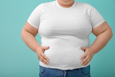 Photo of Overweight woman on color background