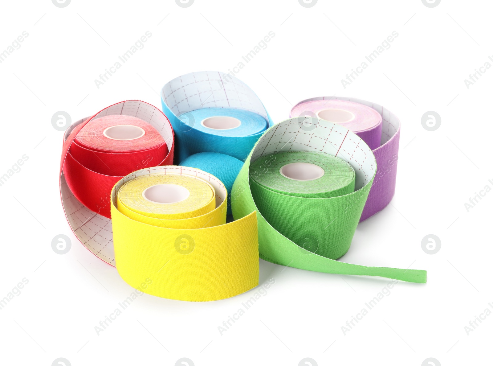 Photo of Many bright kinesio tape in rolls on white background