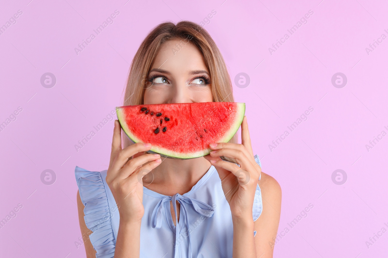 Photo of Pretty young woman with juicy watermelon on color background