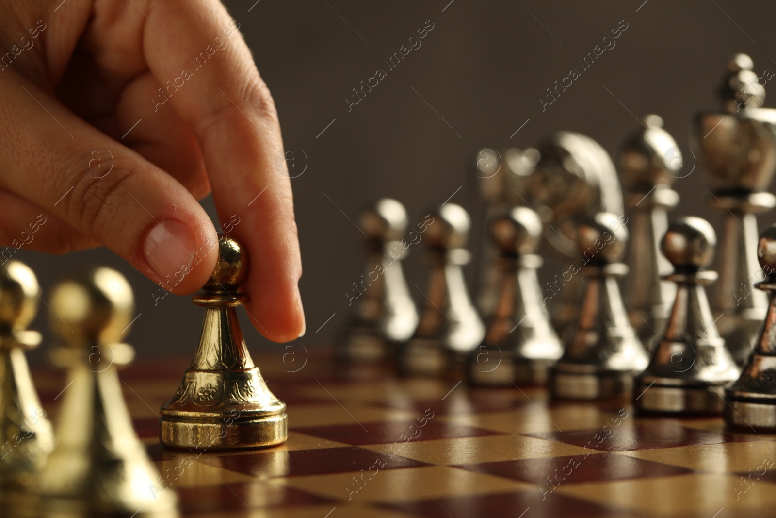 Photo of Woman moving chess piece on board, closeup