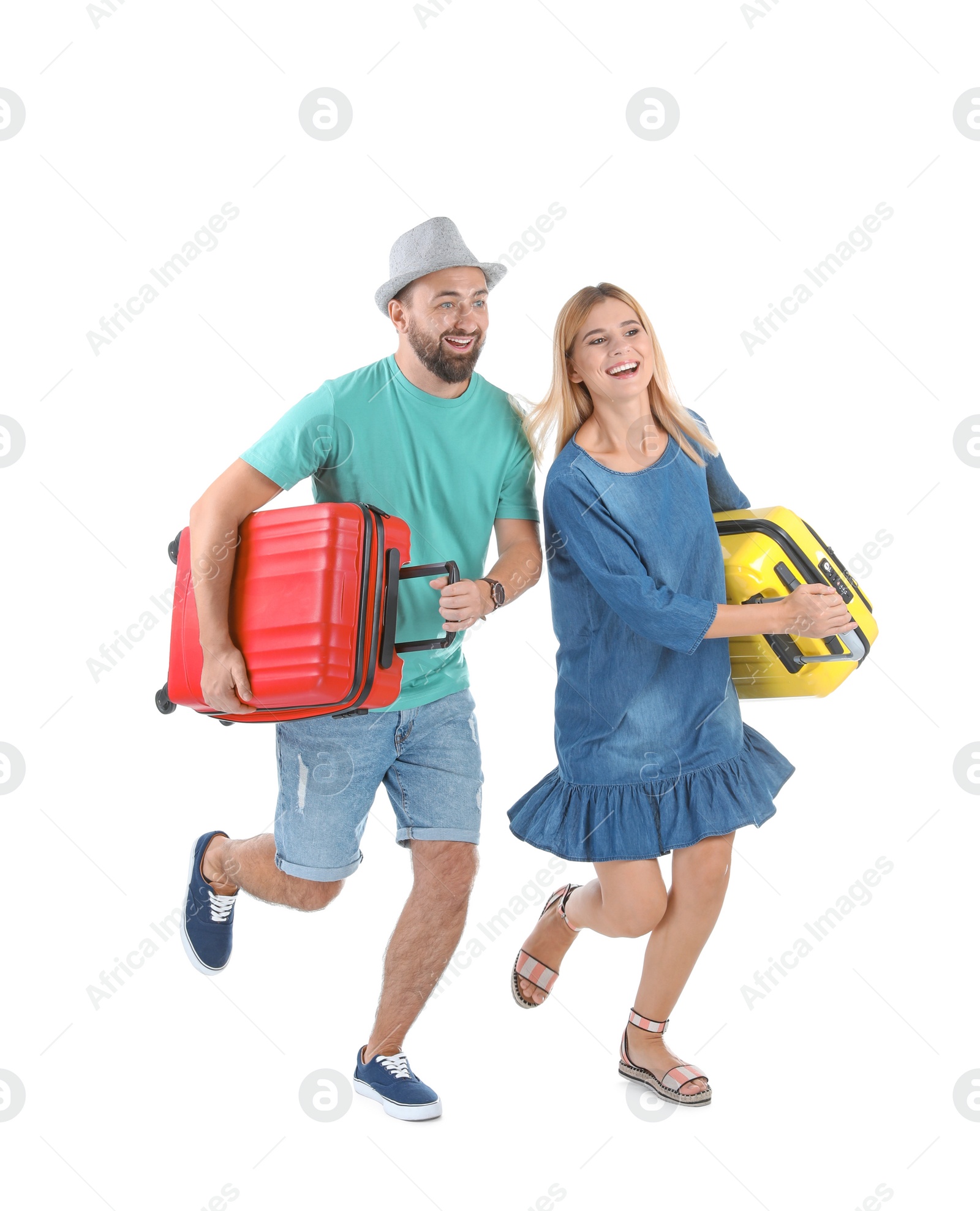 Photo of Couple with suitcases running on white background. Vacation travel