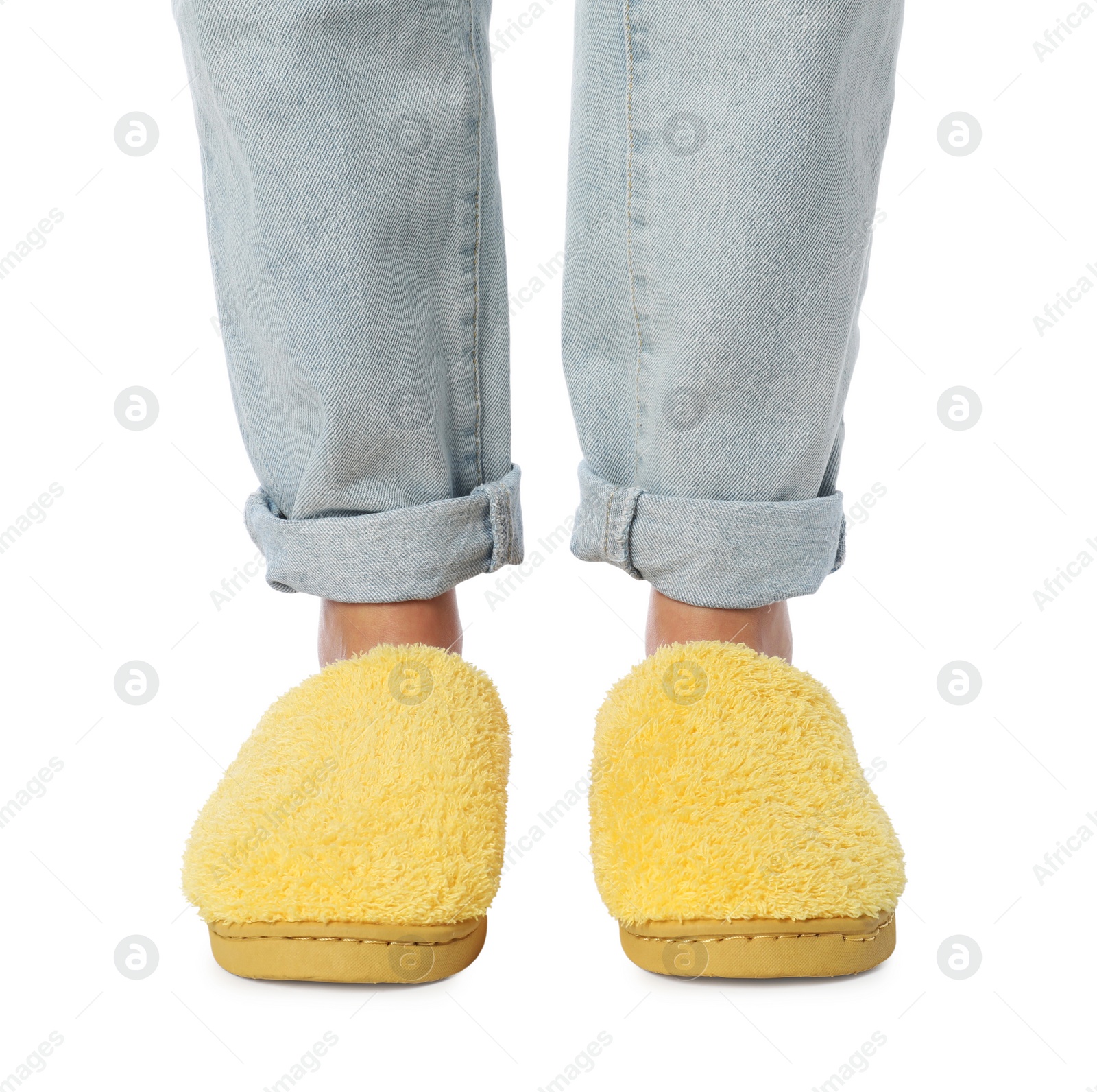 Photo of Woman in yellow soft slippers on white background, closeup