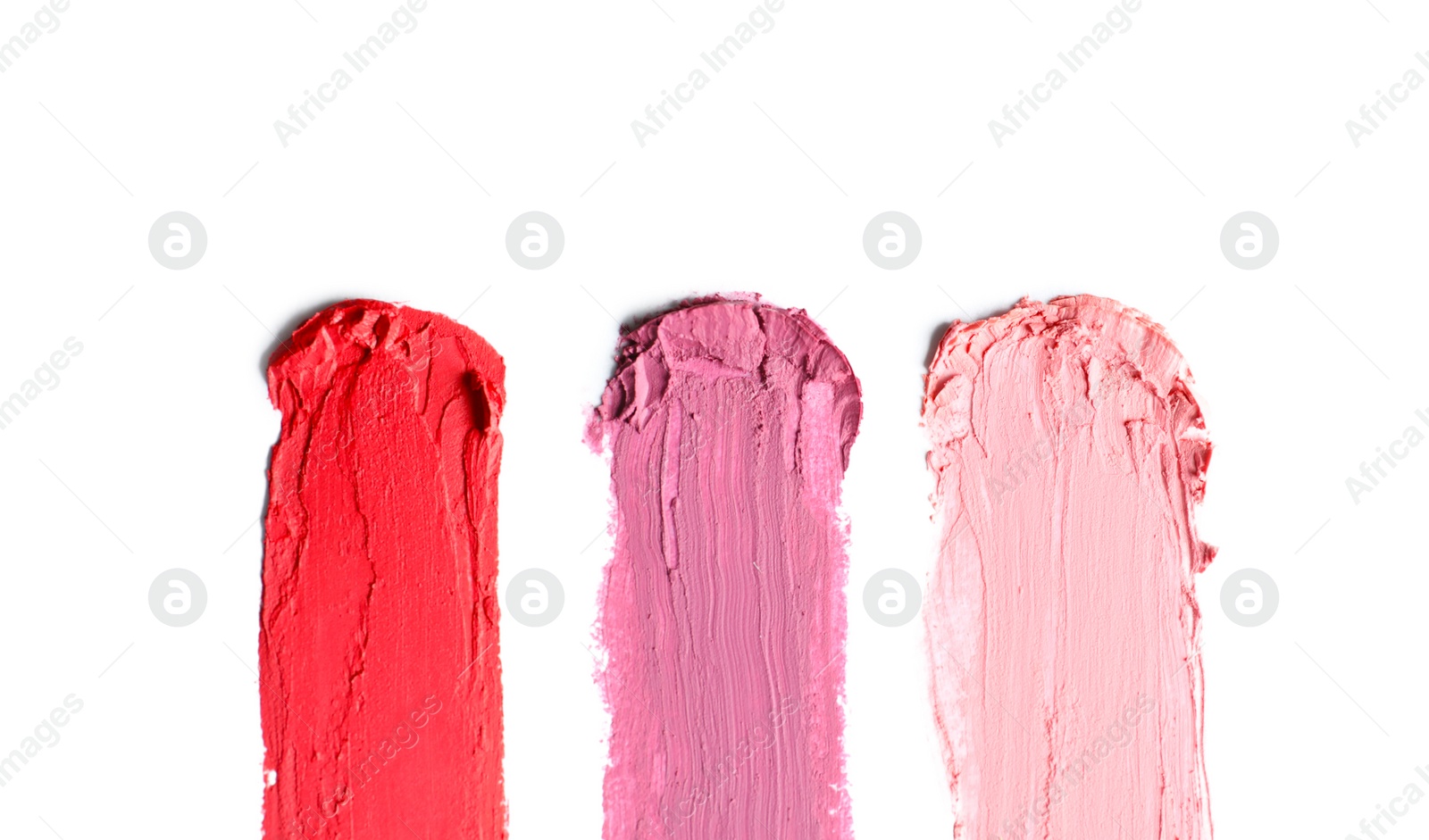 Photo of Strokes of lipstick on white background, top view