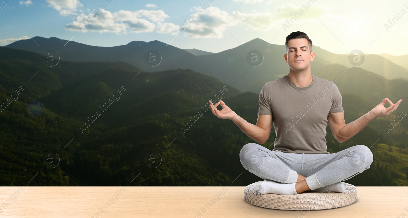 Image of Man practicing yoga on wooden surface against beautiful mountain landscape, space for text. Banner design