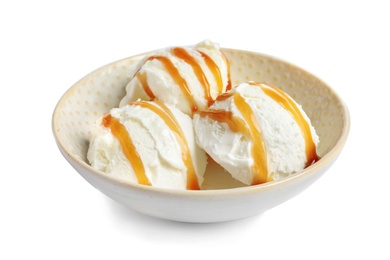 Tasty ice cream with caramel sauce in bowl on white background