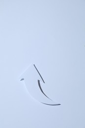 Curved paper arrow on white background, top view. Space for text
