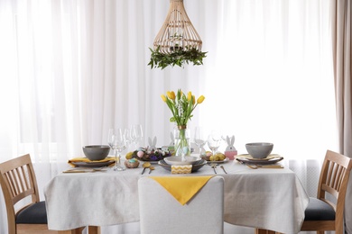 Beautiful Easter table setting with festive decor indoors