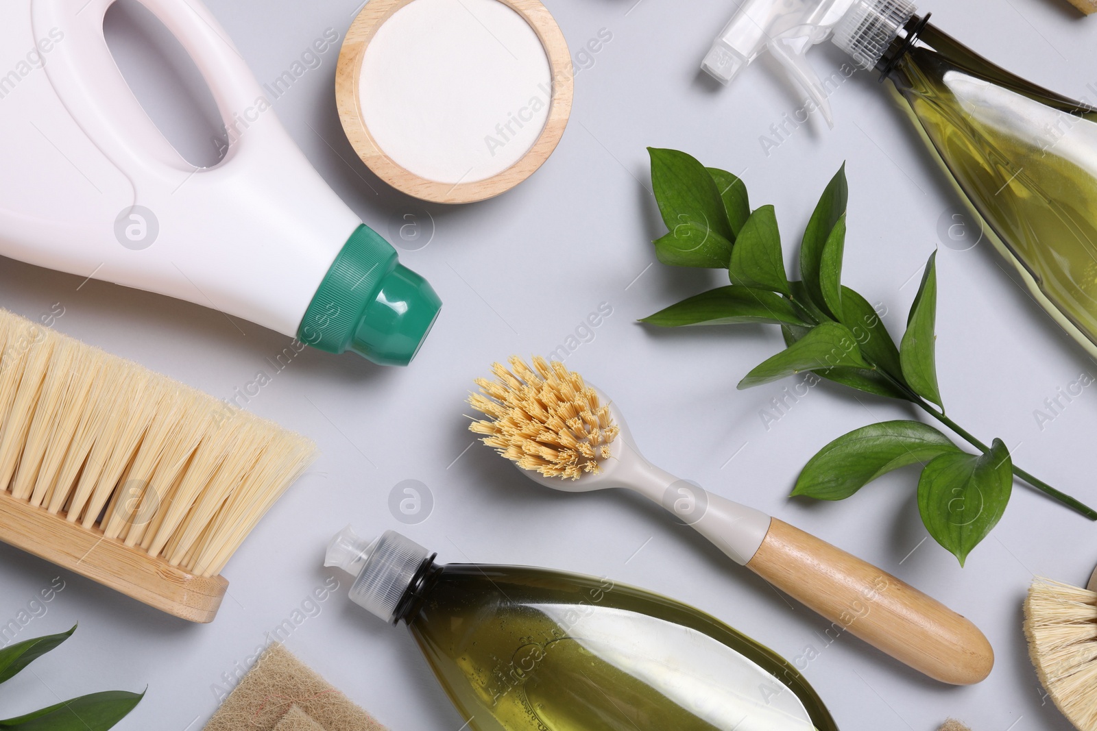 Photo of Flat lay composition with different cleaning supplies on light gray background