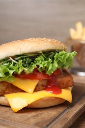 Photo of Delicious burger with tofu, vegetables and sauce on wooden board, closeup