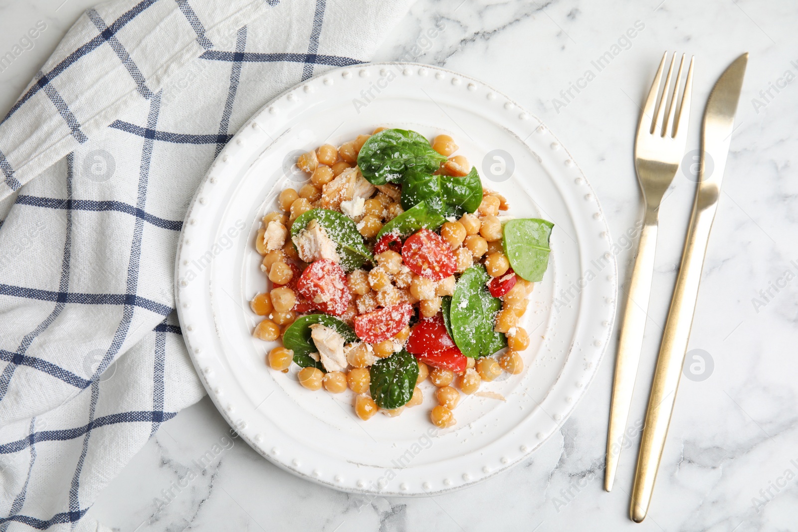 Photo of Delicious fresh chickpea salad served on white marble table, flat lay