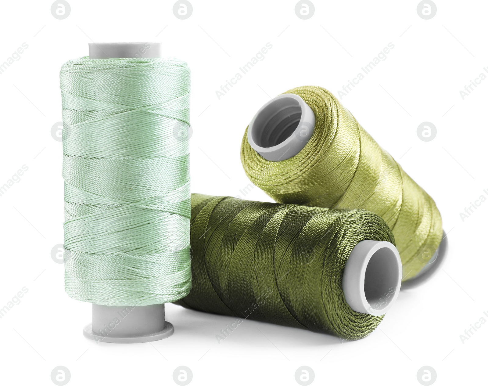 Photo of Set of colorful sewing threads on white background