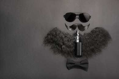 Flat lay composition with artificial moustache and sunglasses on black background, space for text