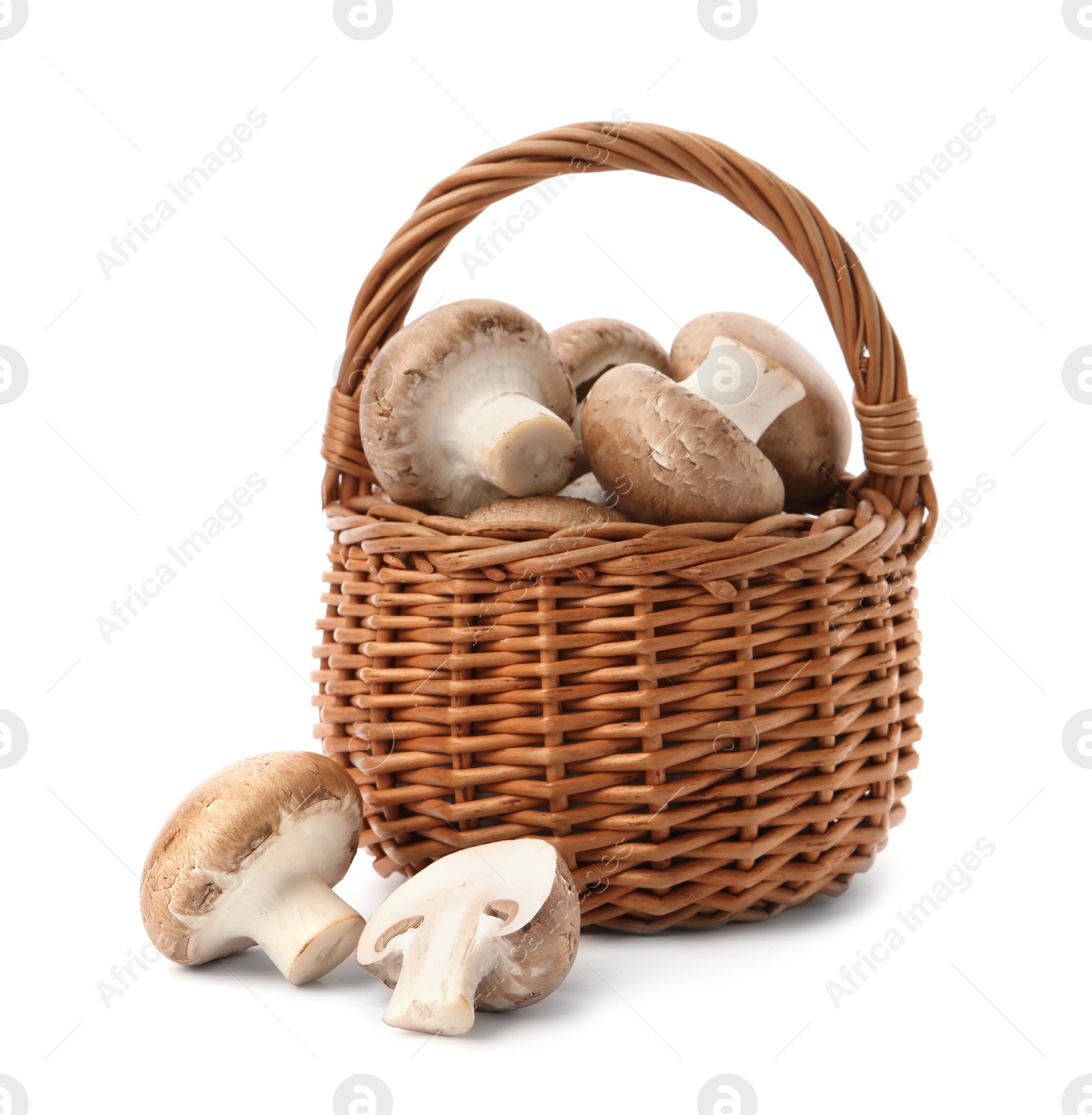 Photo of Wicker basket with fresh raw champignon mushrooms on white background