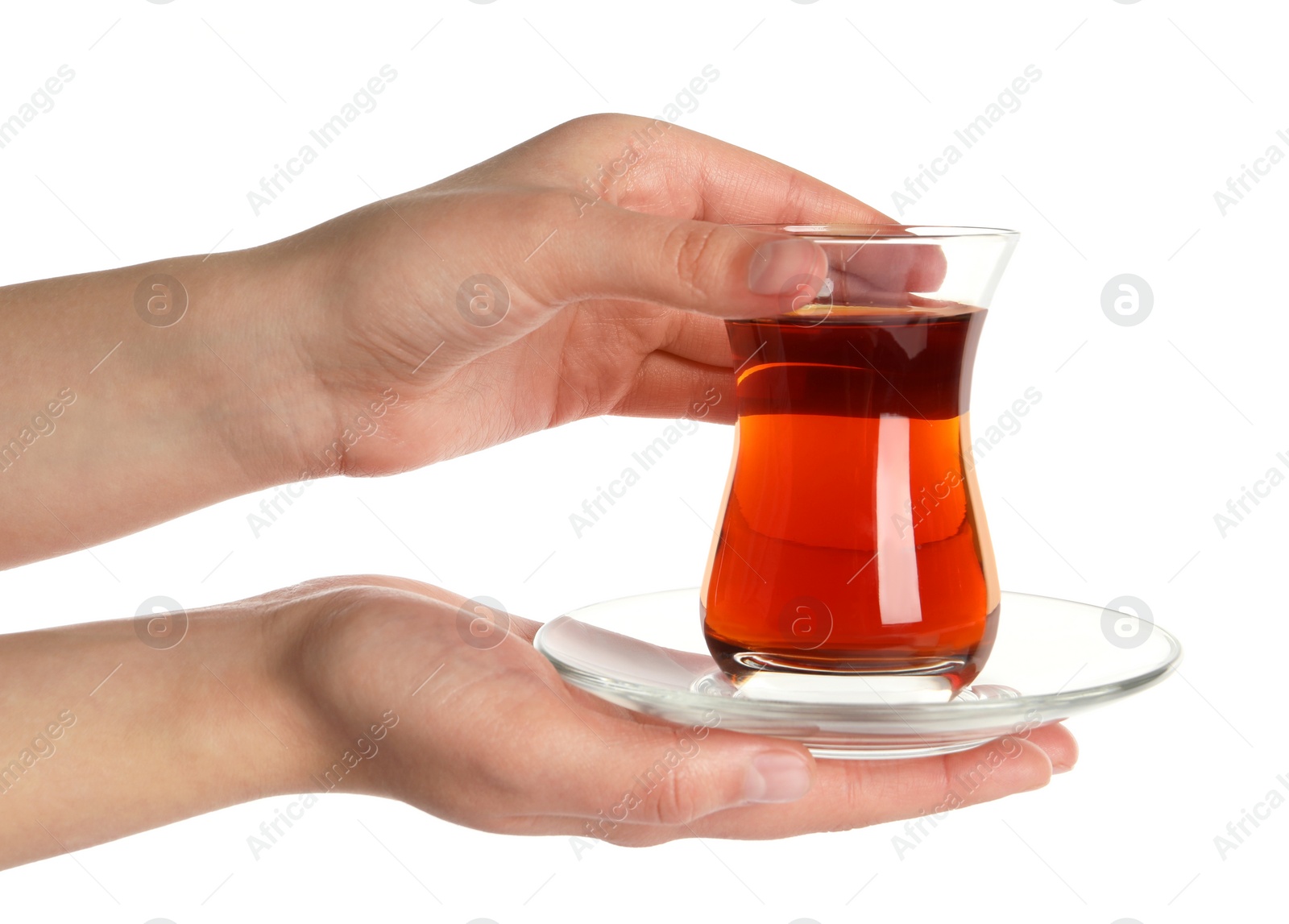 Photo of Woman holding glass of traditional Turkish tea with saucer on white background, closeup