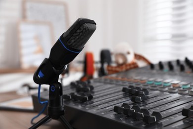 Photo of Microphone and professional mixing console in radio studio