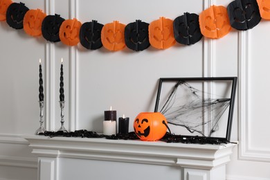 Photo of Different Halloween decor near white wall indoors