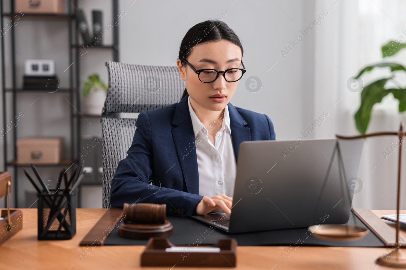 Photo of Notary working with laptop at table in office