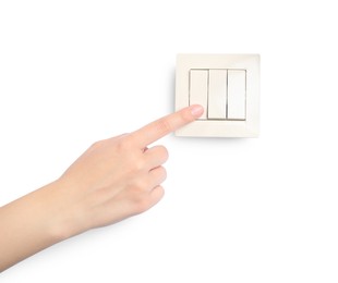 Woman pressing light switch on white background, closeup