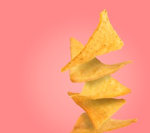 Image of Stack of tasty tortilla chips on salmon color background, space for text