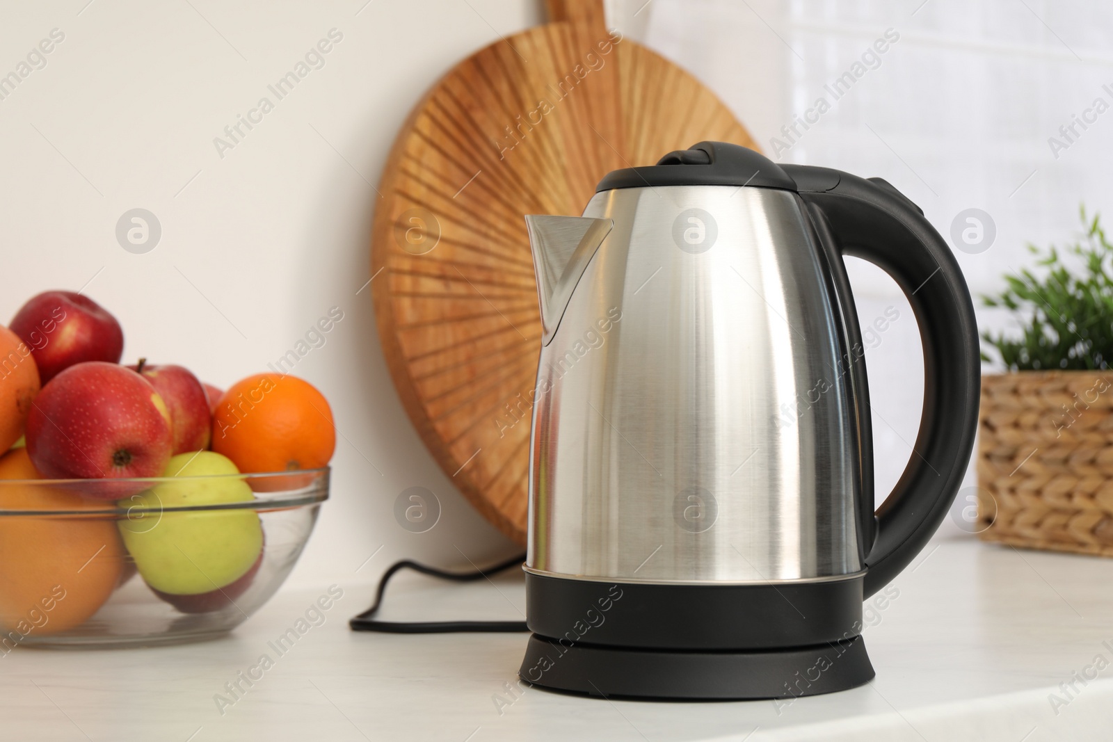 Photo of Modern electric kettle on counter in kitchen