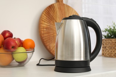 Modern electric kettle on counter in kitchen