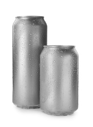 Photo of Aluminum cans of beverage covered with water drops on white background. Space for design
