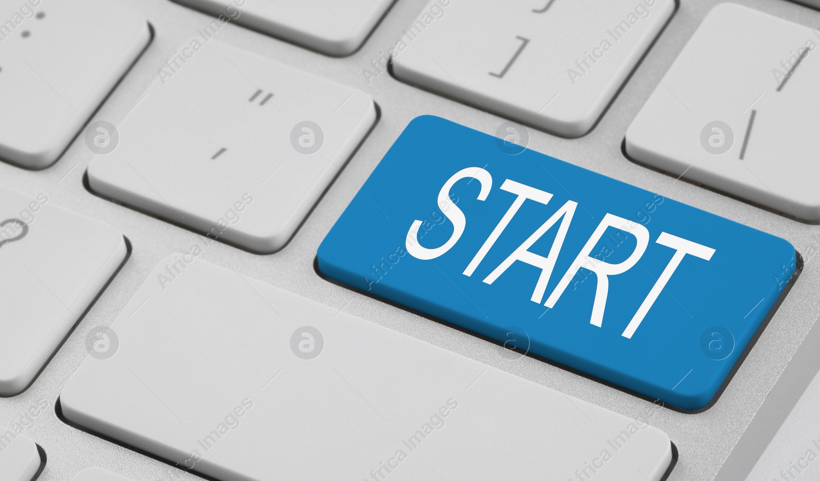 Image of Light blue button with word Start on computer keyboard, closeup