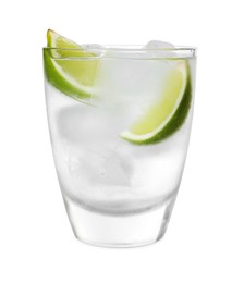 Photo of Glass of vodka with ice and lime isolated on white