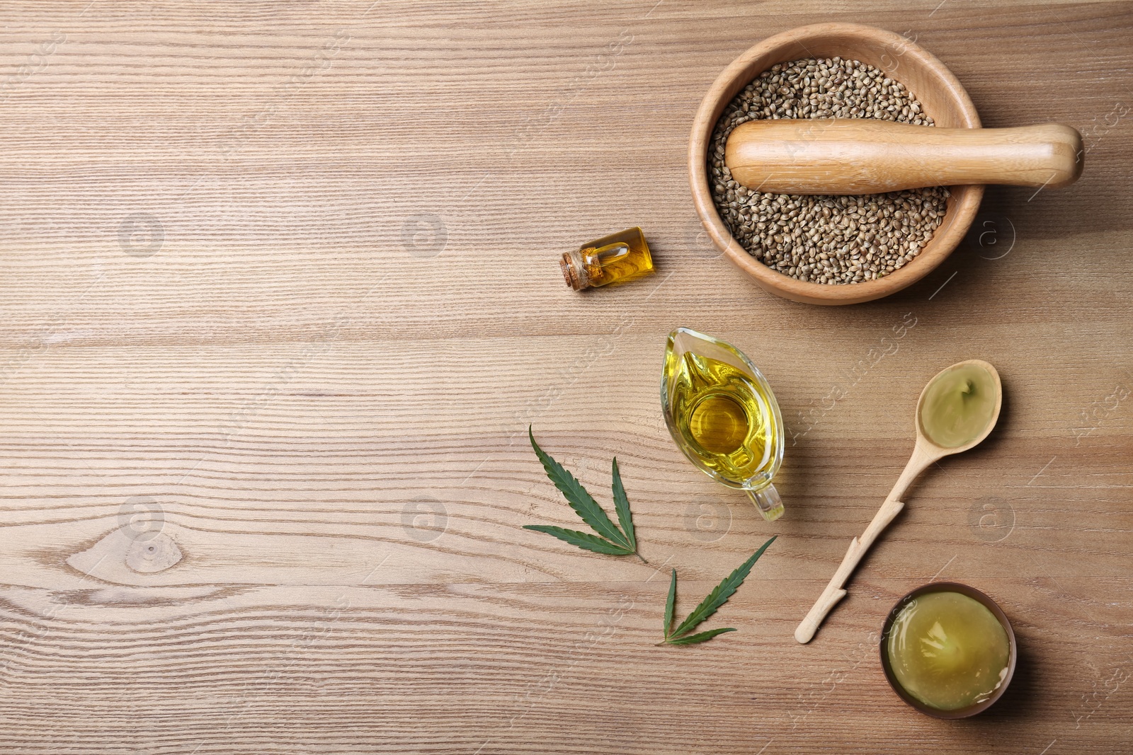 Photo of Flat lay composition with hemp lotion and space for text on wooden background