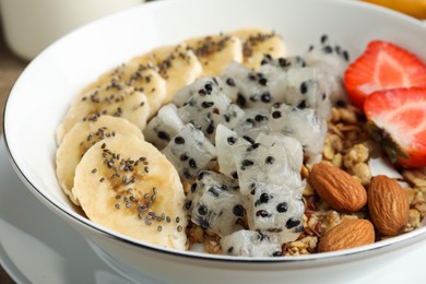 Photo of Granola with pitahaya, banana and strawberry in bowl, closeup