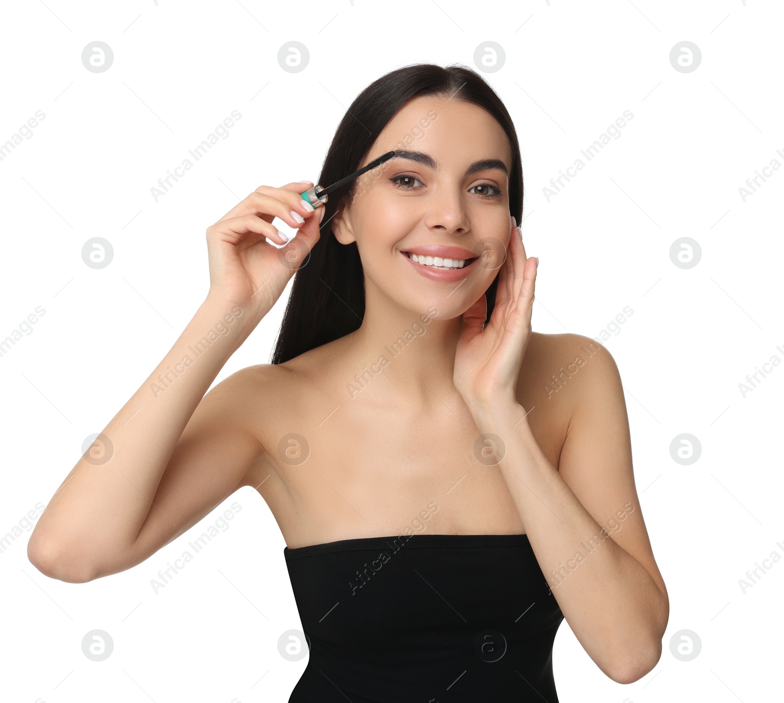 Photo of Beautiful young woman applying mascara on white background