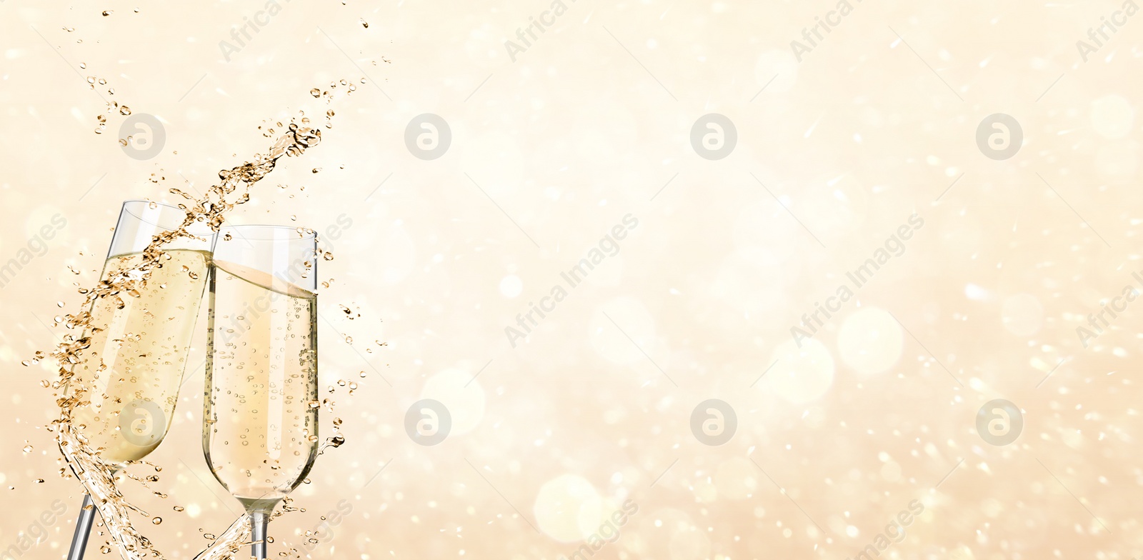 Image of Glasses with sparkling wine and splashes on light background, space for text. Banner design