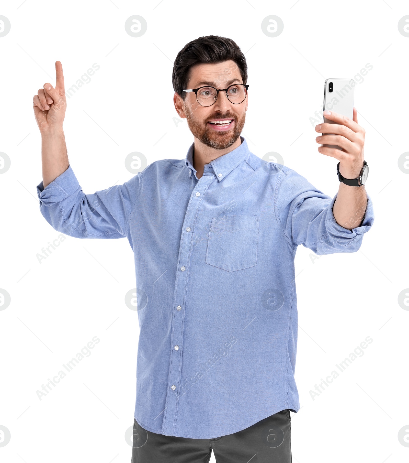 Photo of Smiling man taking selfie with smartphone on white background