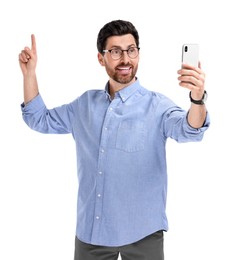 Photo of Smiling man taking selfie with smartphone on white background