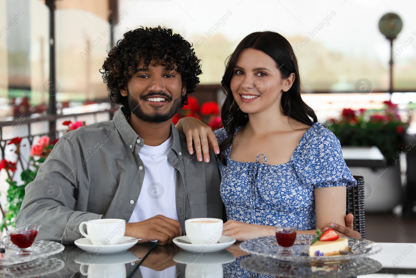 Photo of International dating. Happy couple spending time together in restaurant